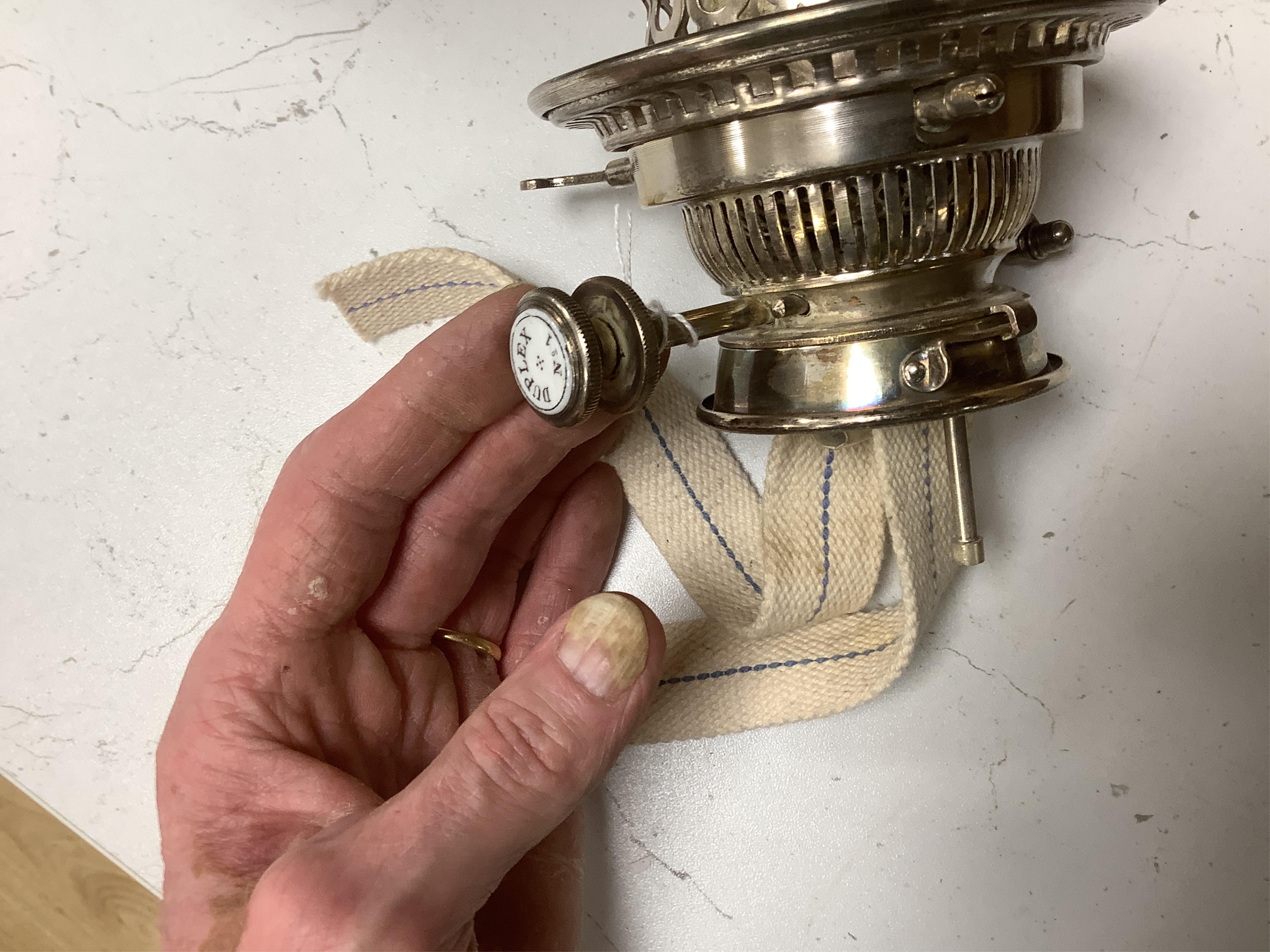 A silver plated oil lamp in the form of a Corinthian column with cut glass reservoir, 76cm high. Condition - fair to good, missing chimney and shade